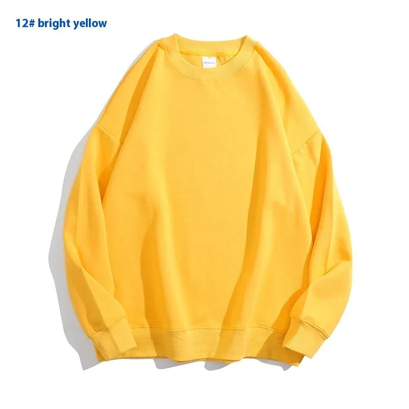 A loose-fitting, off-shoulder cotton sweater in a solid colour with long sleeves and a round neck.