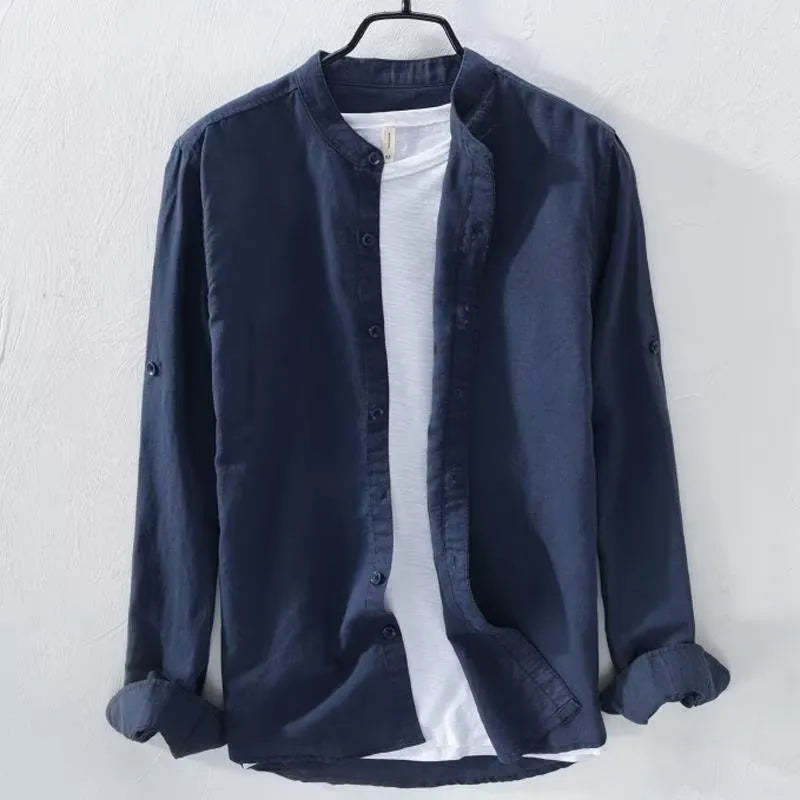 Man wearing a loose-fit light blue long sleeve cotton linen casual shirt.