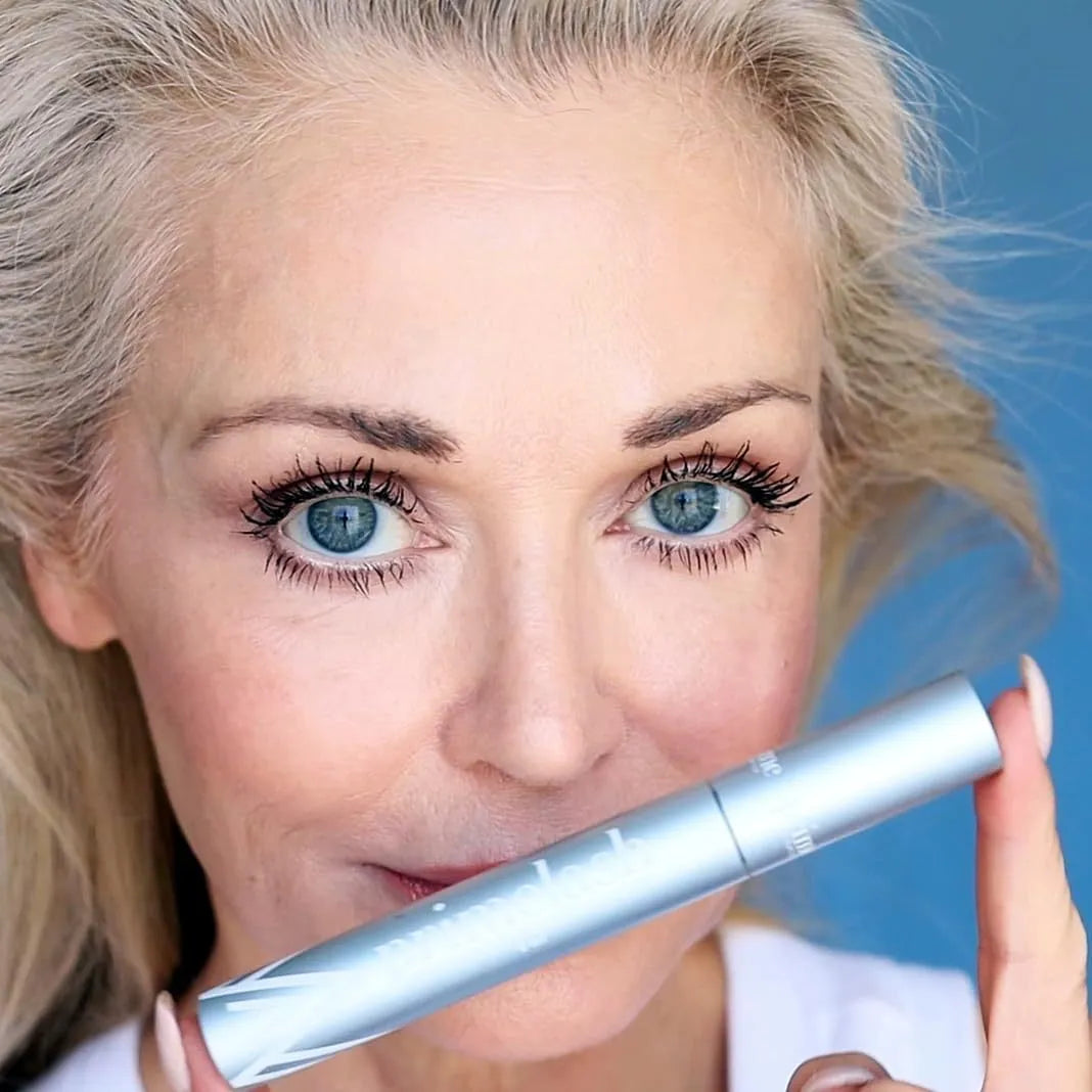 A single black eyelash brush and comb beauty tool on a white background.