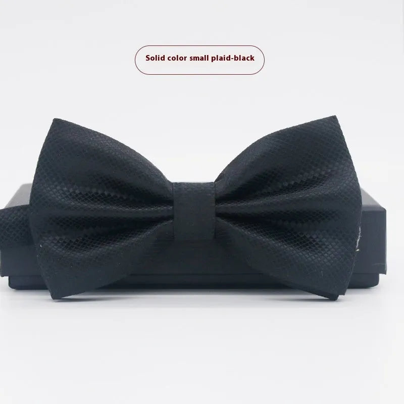 Men's flat head style polyester bow tie in a solid colour, shown with adjustable neck strap.