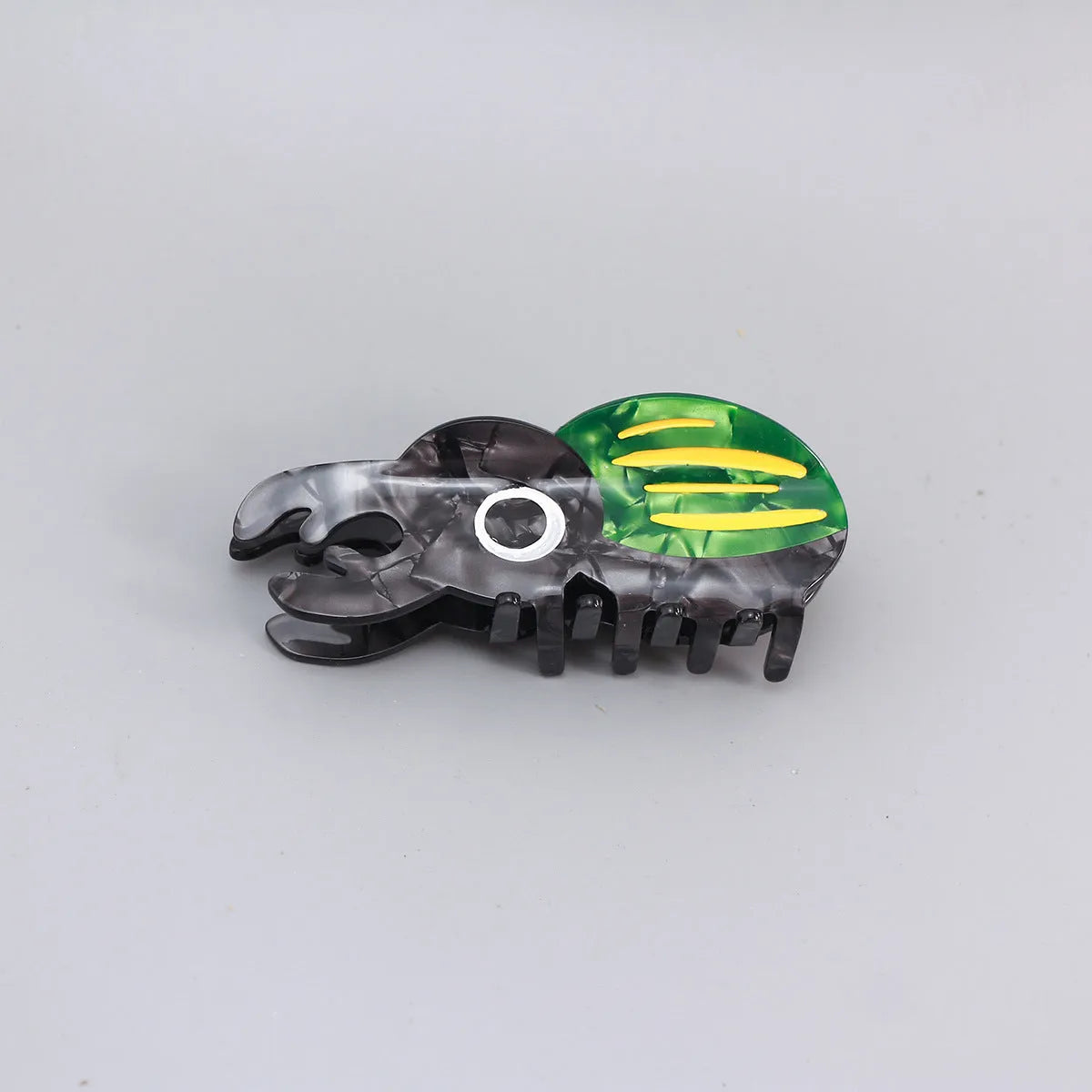 Handmade cellulose acetate insect grip with green beetle, orange beetle, and white caterpillar models for biology study.