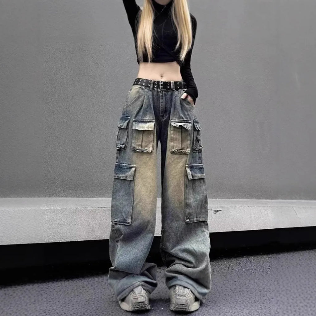Loose fit distressed denim trousers with multiple pockets in light blue colour