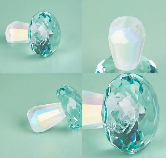 Set of four colourful crystal mushroom decorations in transparent, green, red, and yellow on a white background.