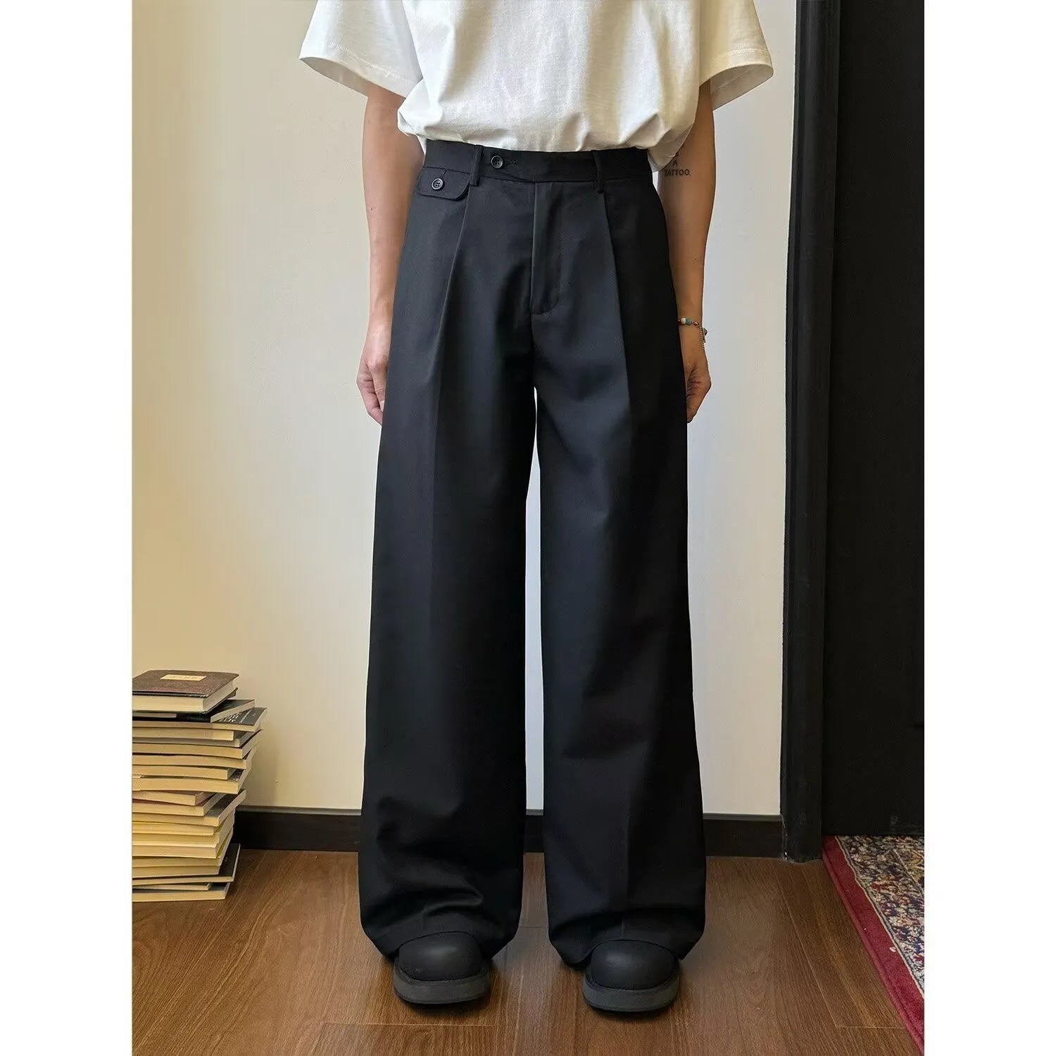 Men's brown wide-leg straight-cut casual trousers made from a polyester blend fabric on a hanger.