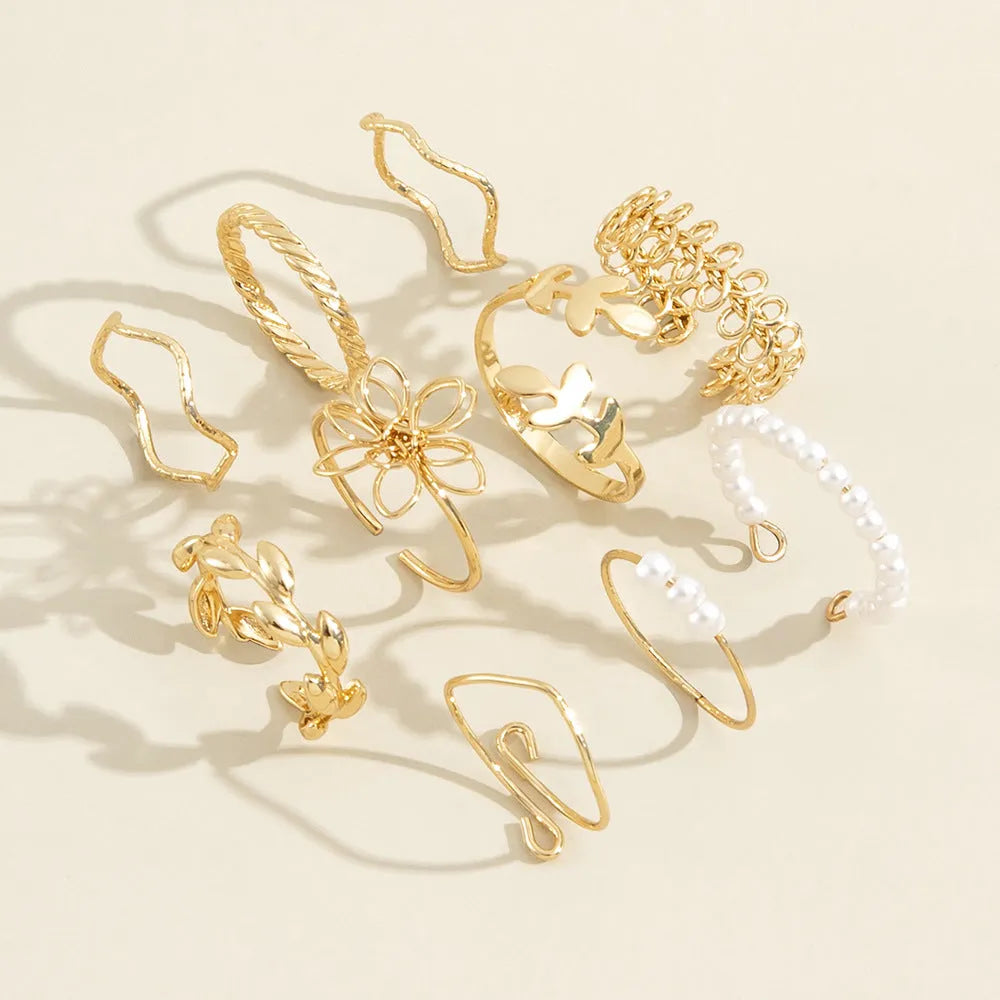 Gold tone openwork flower ring with electroplated glossy finish and women's jewellery design