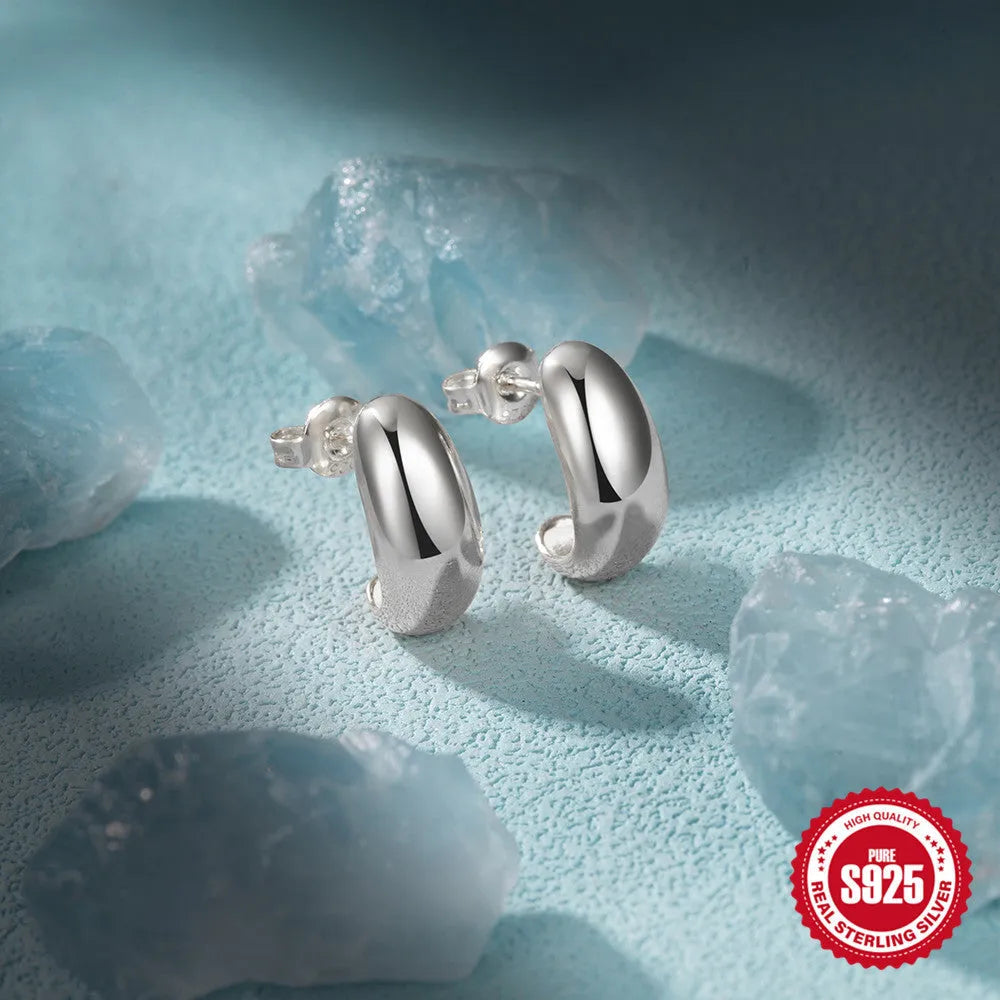 C-shaped sterling silver stud earrings with high polish gloss finish in gold colour