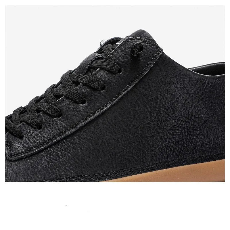 Men's black casual leather shoes with a round toe and white rubber sole on a plain background.