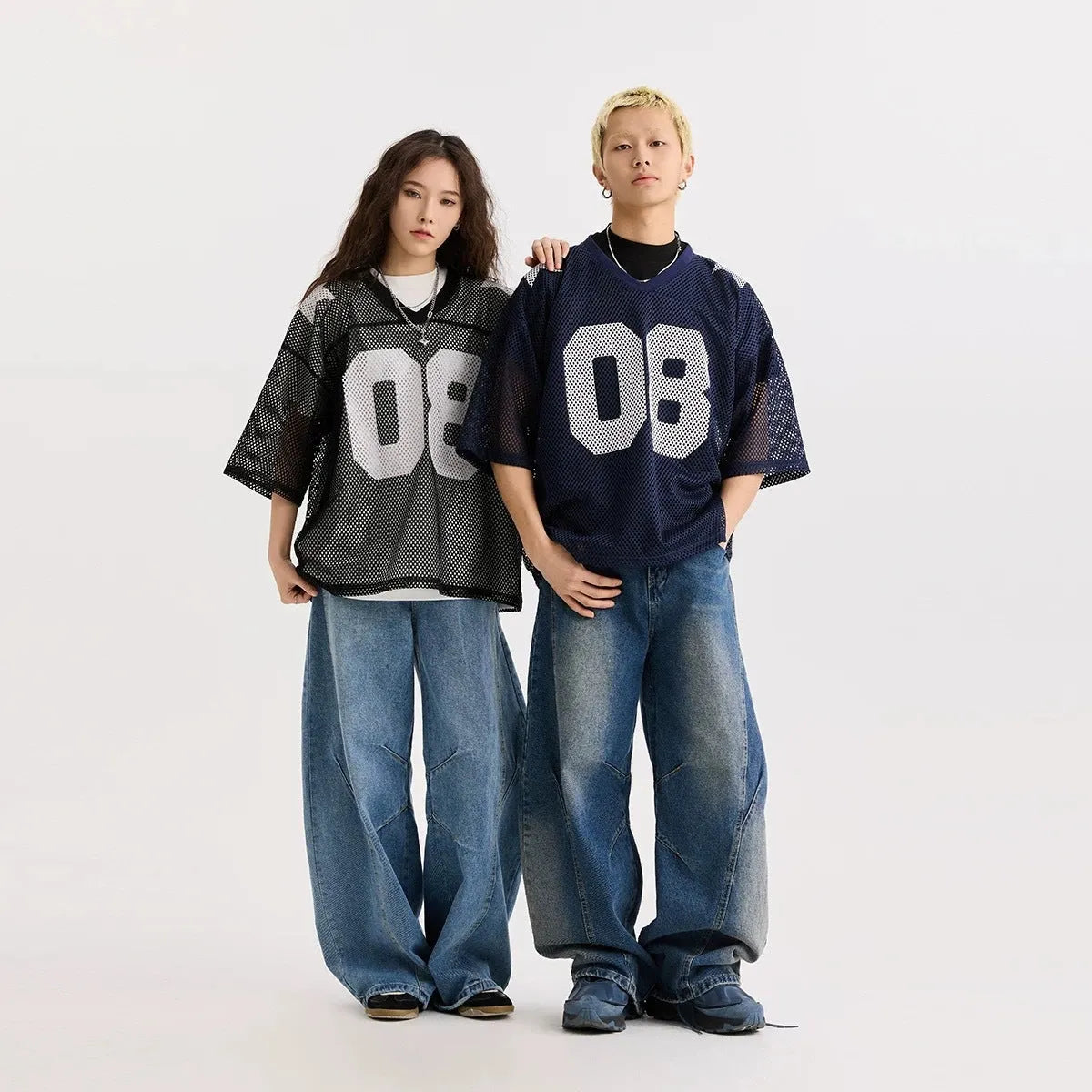 Black loose fit pullover shirt with white letter pattern design, short sleeves.