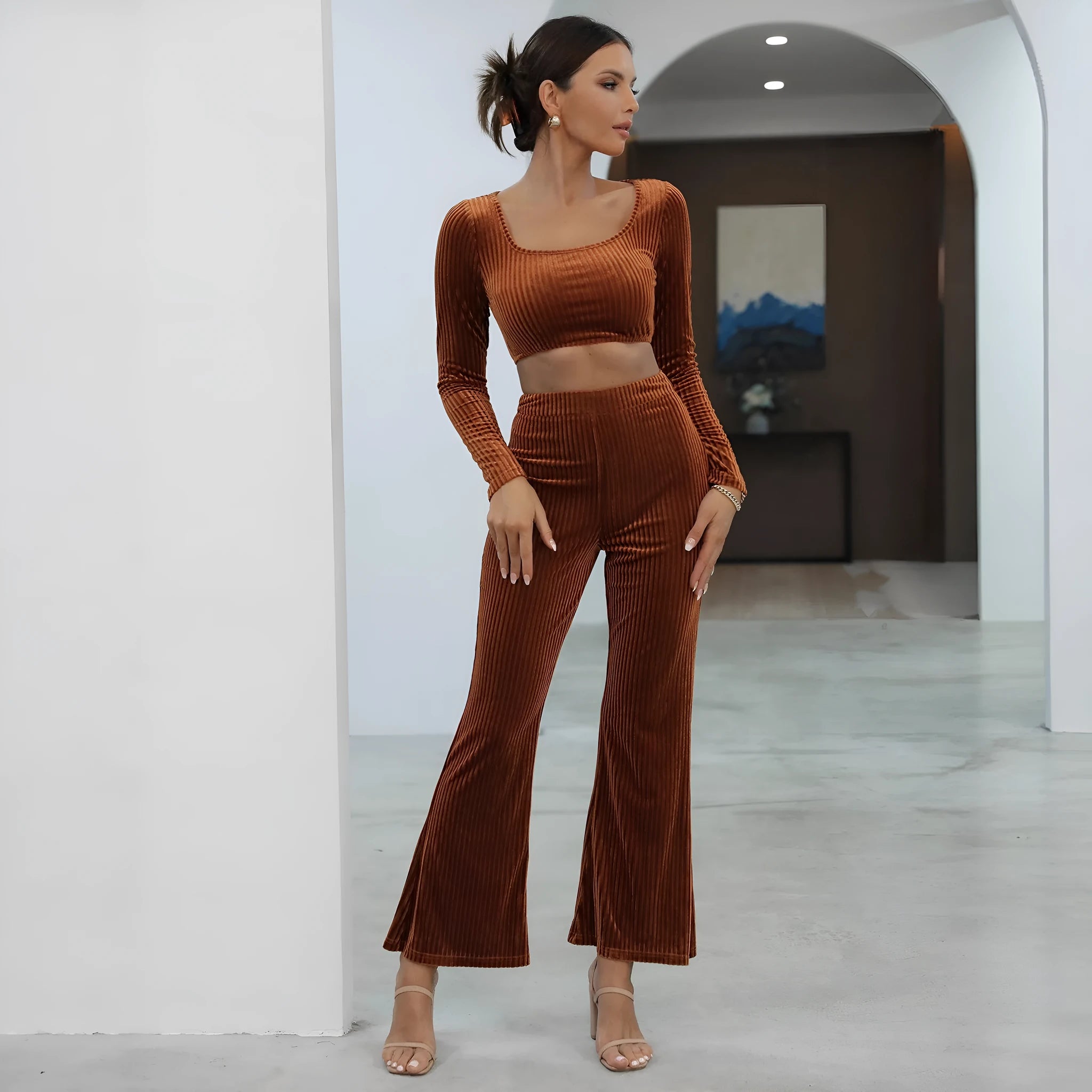 Caramel coloured long sleeve sweater and matching trousers lounge set on a hanger