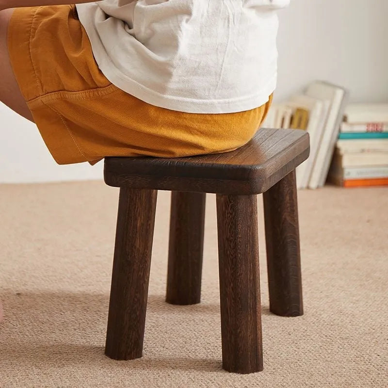 Distressed solid wood household stool with a bracket structure frame for shoe changing.