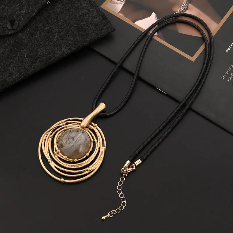 Vintage gold sweater chain necklace with large round plaid pendant on adjustable snakeskin wax rope.