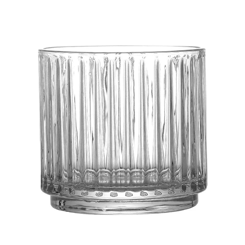 Stackable engraved glass wine glasses and sake barrel on a table