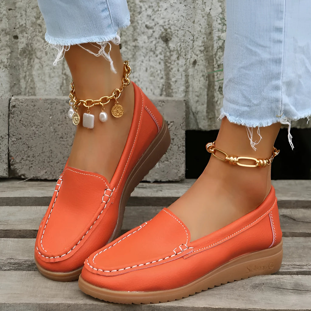 Women's black PU leather flat shoes with round toe and visible car suture stitching detail.