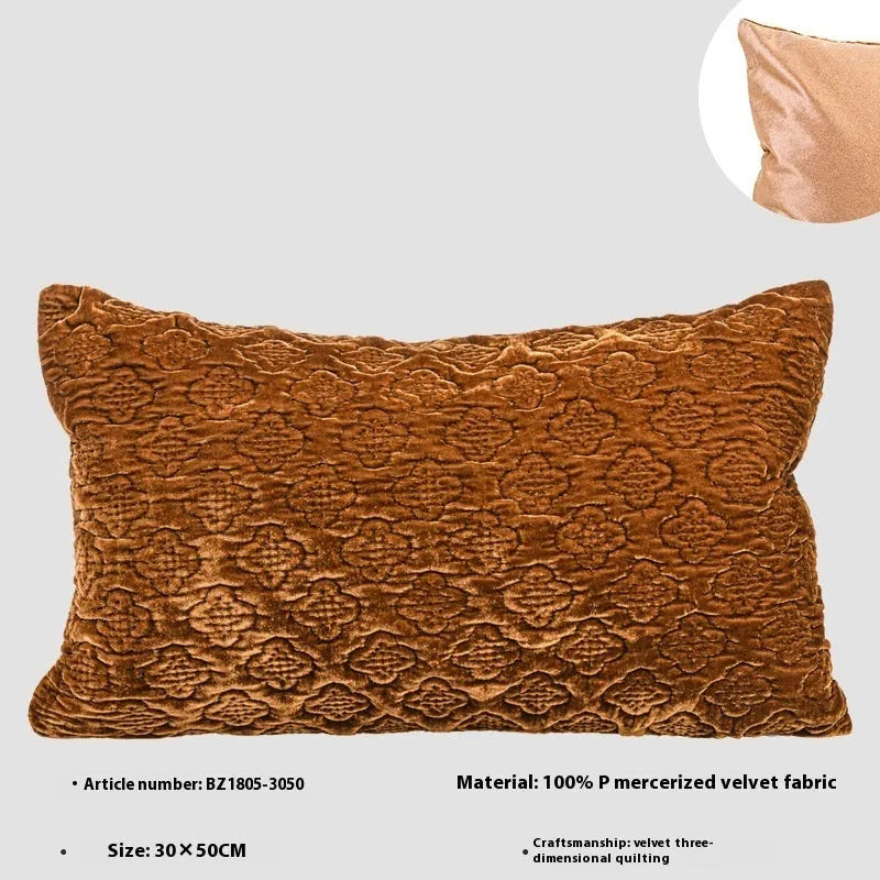 Brown gold antique style three-dimensional quilted cushion pillow on a sofa.