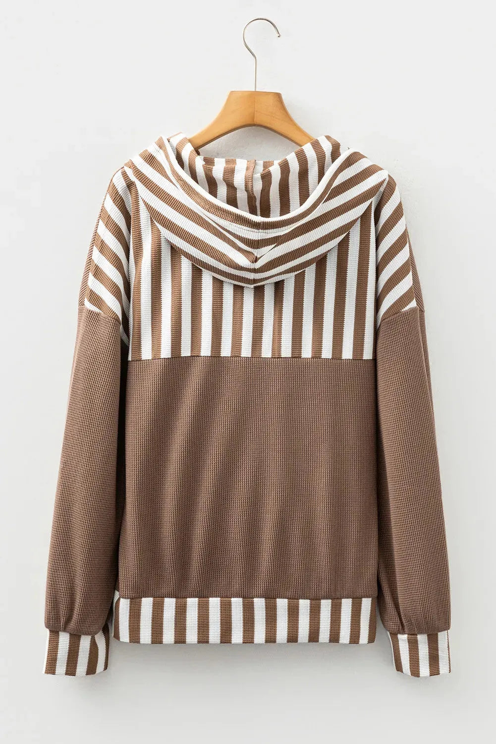 Straw yellow hoodie with waffle texture and striped patchwork design, featuring a button neck and drawstring hood.