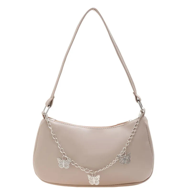 Women's black PU leather crossbody bag with butterfly chain shoulder strap showing internal phone pocket