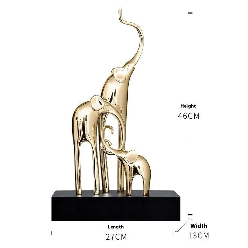 Detailed resin elephant figurine ornament in metallic gold finish on a wooden shelf.