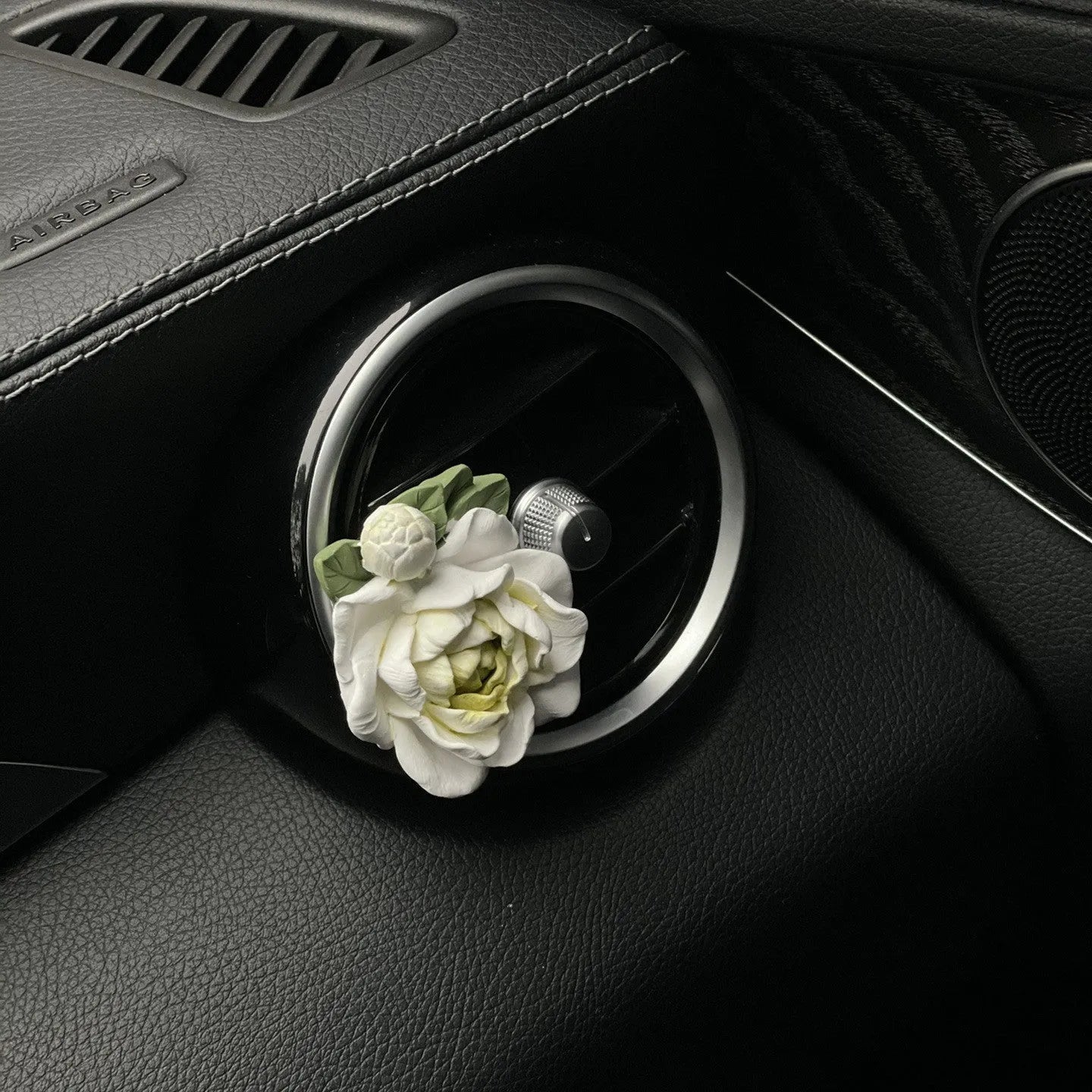 Solid jasmine car perfume for air vent with gypsum base and essential oil bottle in beige white or green.