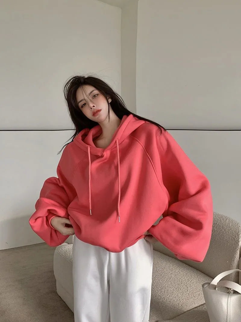 Watermelon red women's loose fit mulberry silk hooded sweater on a hanger.