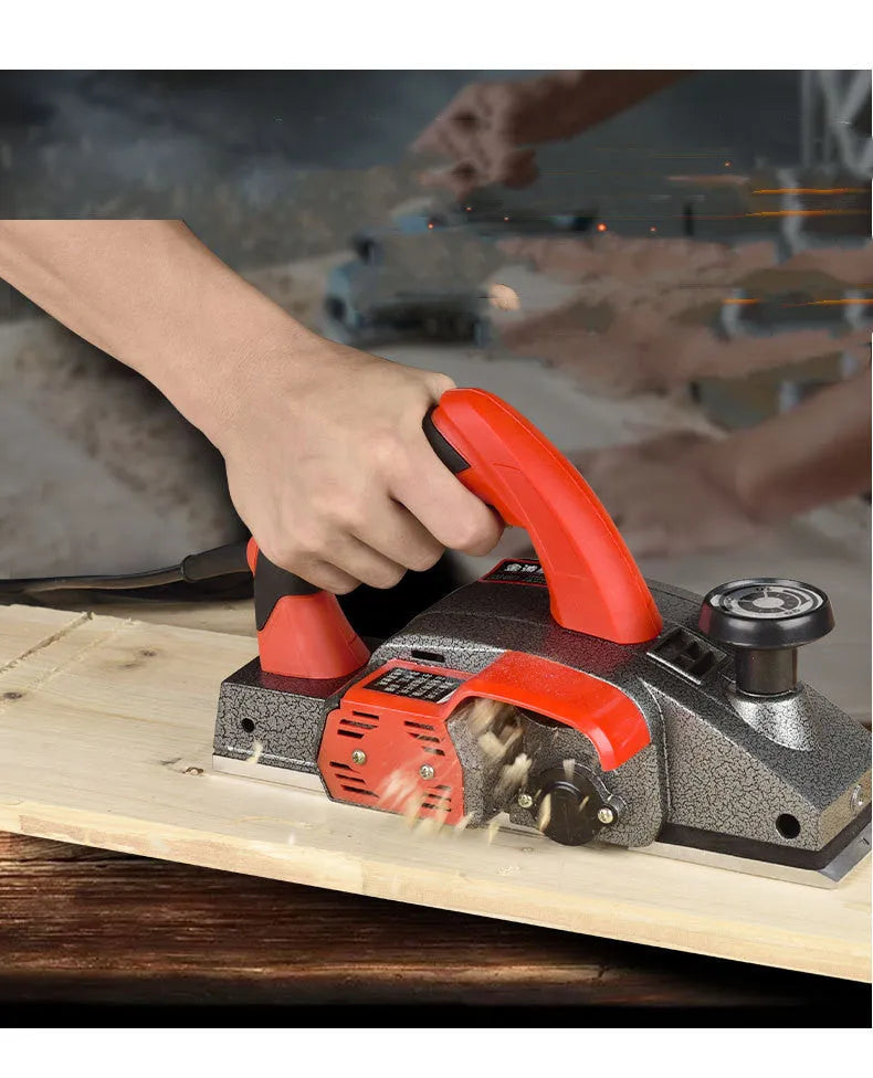 Red desktop electric wood planer with aluminium body showing 82mm cutting width