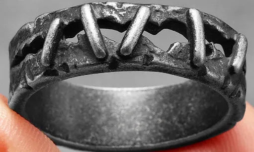 Stainless steel ring featuring dark punk stitching and a double ring design on a hand.