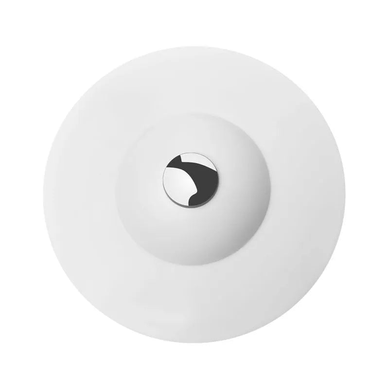 UFO-style silicone press sink drain cover in white on a modern kitchen sink