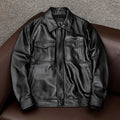 Man wearing a black loose-fit lapel PU leather jacket with side pockets.
