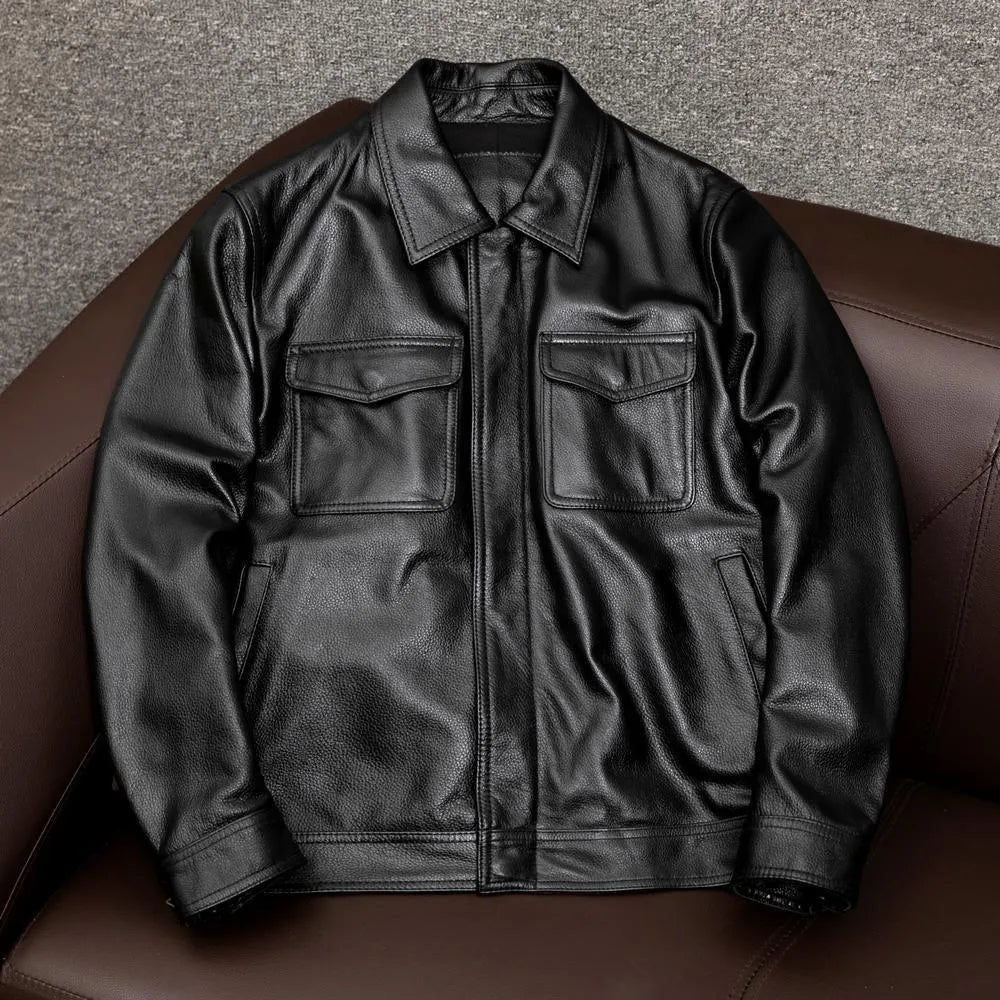 Man wearing a black loose-fit lapel PU leather jacket with side pockets.