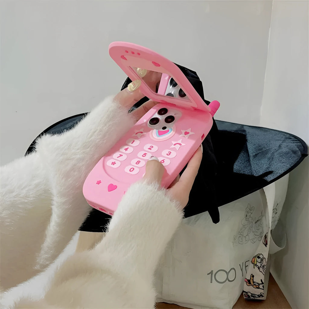 Light pink silicone flip phone case with mirror for iPhone, showing cute cartoon design.