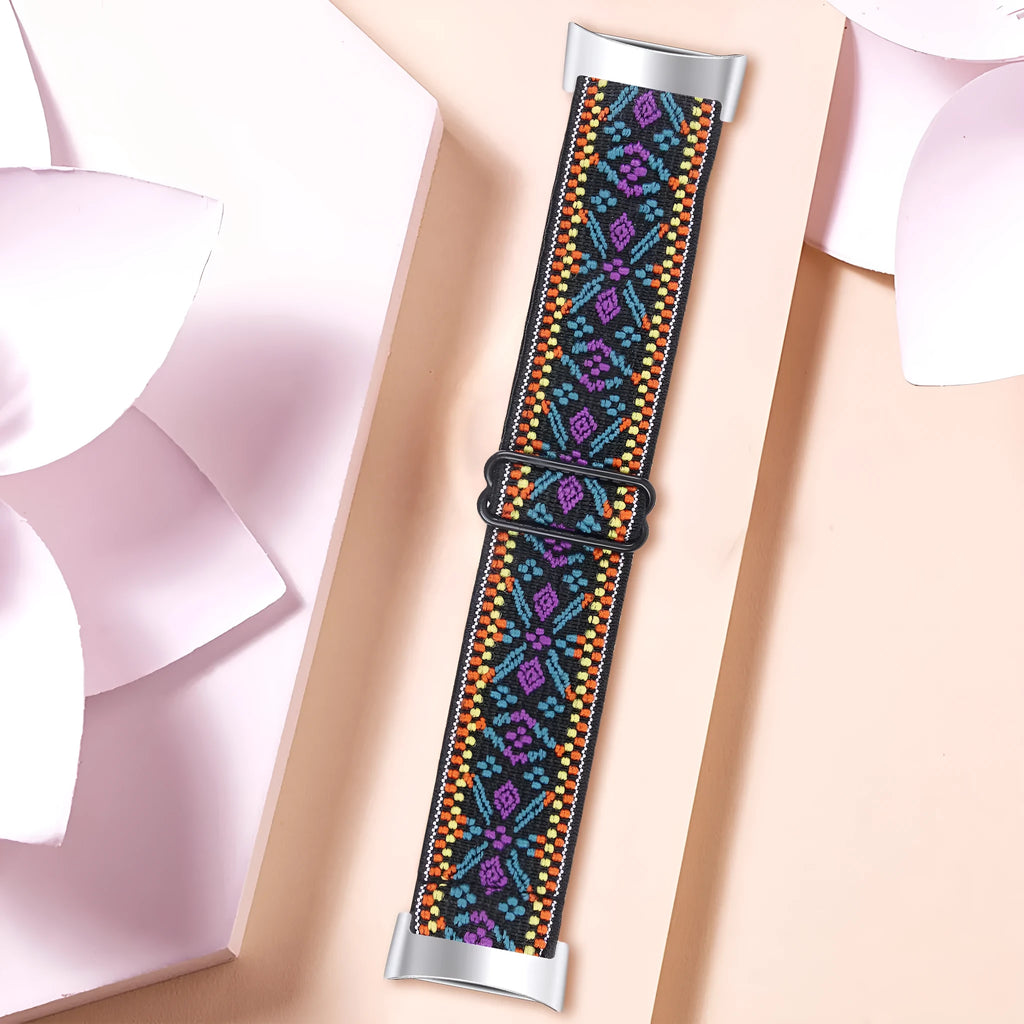 Printed elastic watch strap for Fitbit Charge 6 showing rainbow and arrow print options