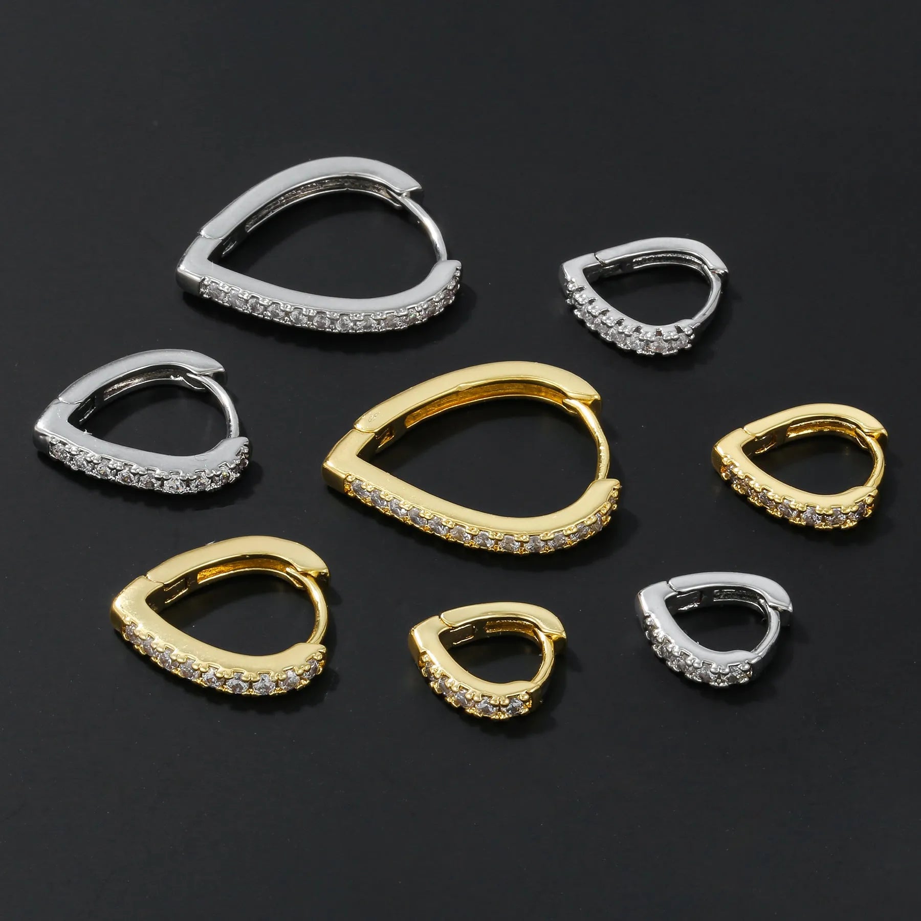 Gold geometric heart-shaped clip-on earring for women on a white background.