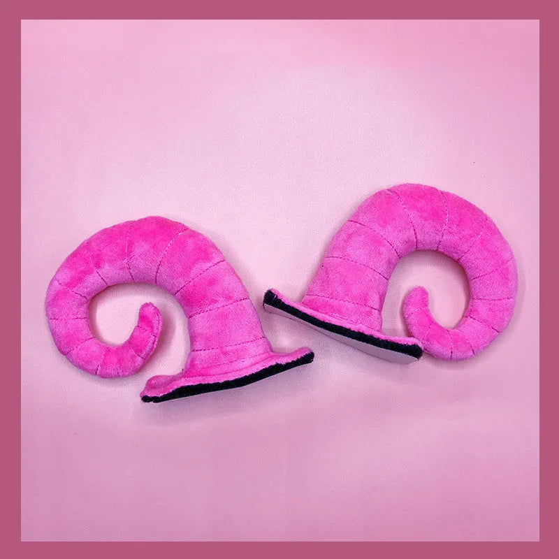 A pair of composite fibre demon bull horn ornaments for motorcycle helmet customisation.