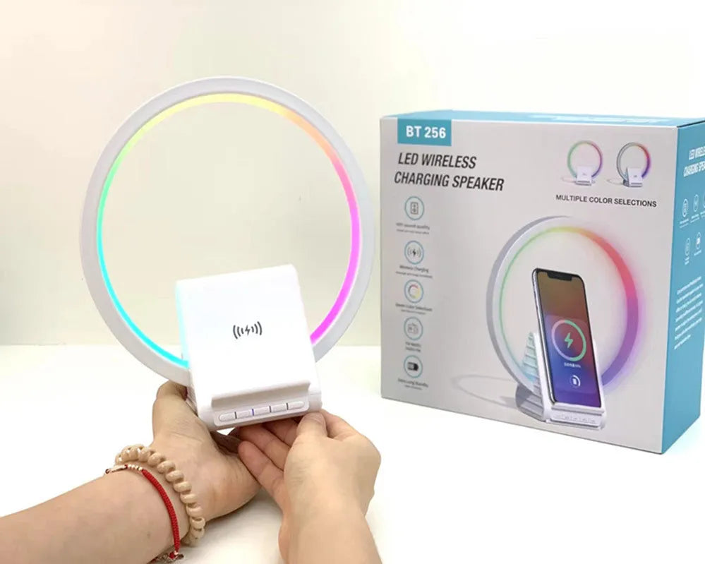 White smart Bluetooth speaker with wireless charging pad, ambience light, and card slot on a desk