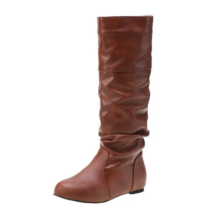 Women's flat ankle boots in black with a round toe and slip-on design on a rubber sole.