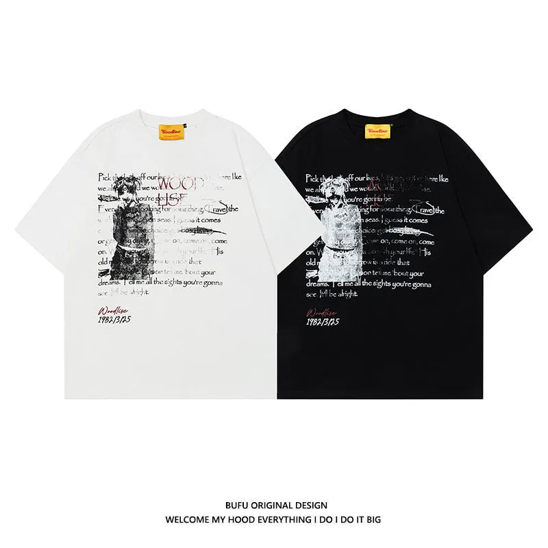 Man modelling a black loose-fit pure cotton T-shirt with a white printed letter pattern and raglan short sleeves