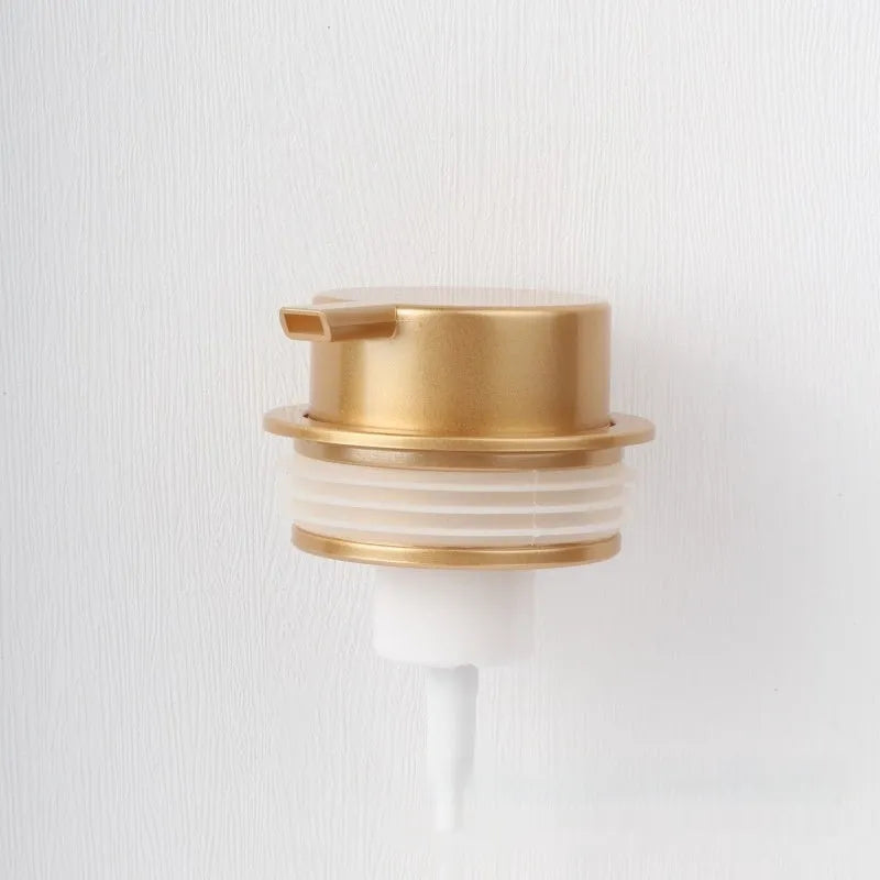 Large plastic foam pump dispenser for facial cleansers in a metallic gold finish