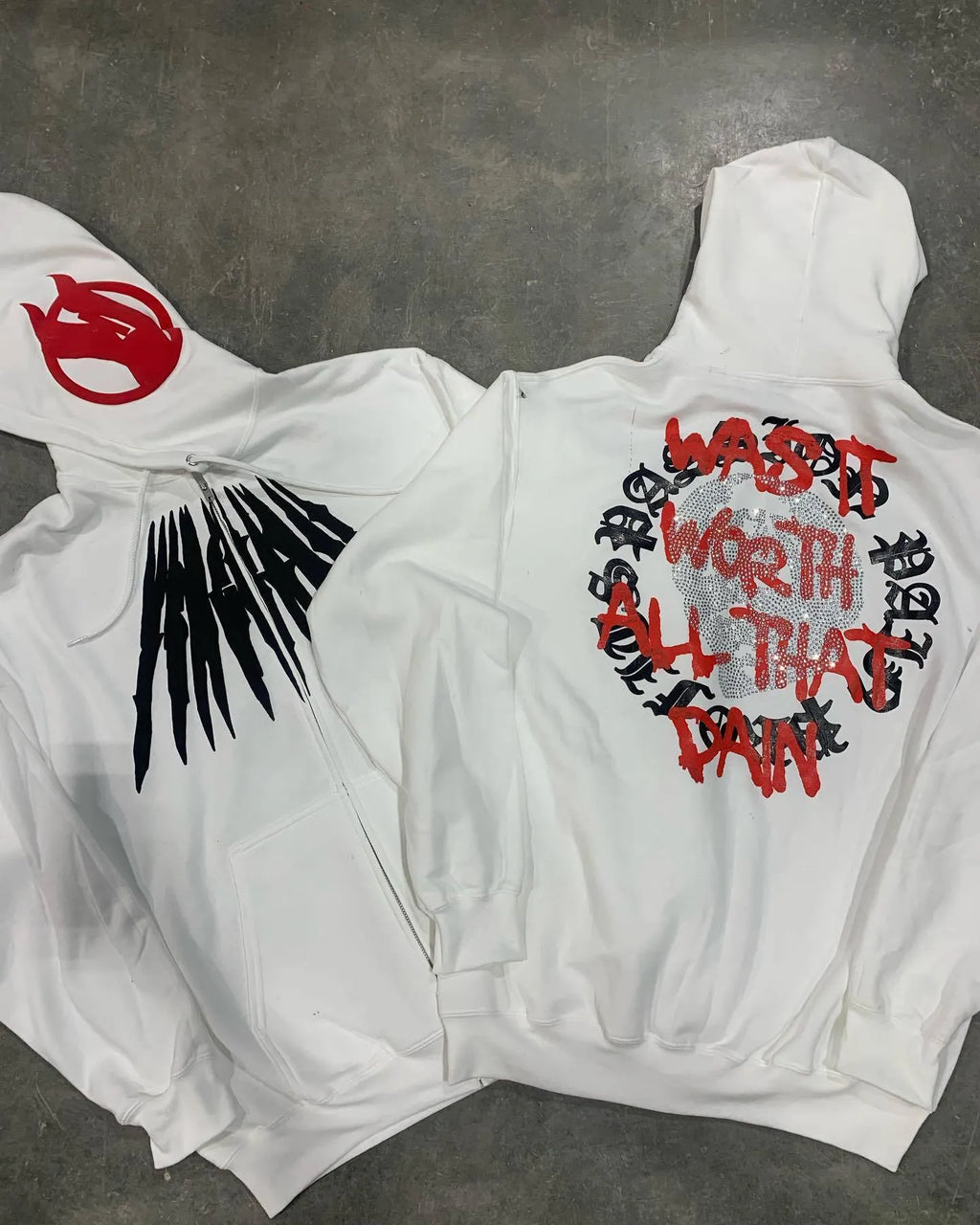 Black loose hooded sweatshirt with white printed skull design and rhinestone details, cardigan style.