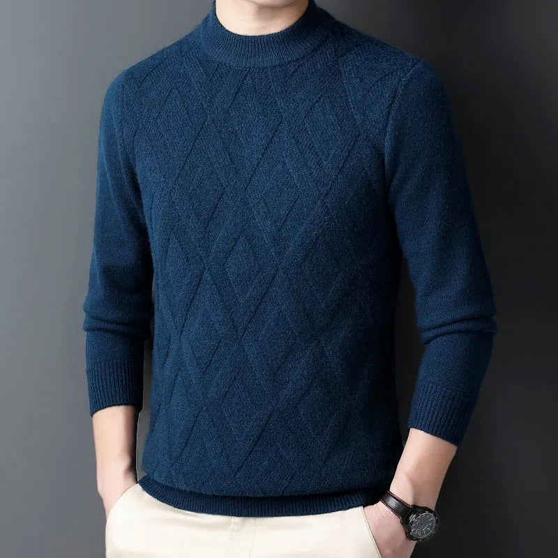 Man wearing a thick grey diamond jacquard knit pullover sweater.
