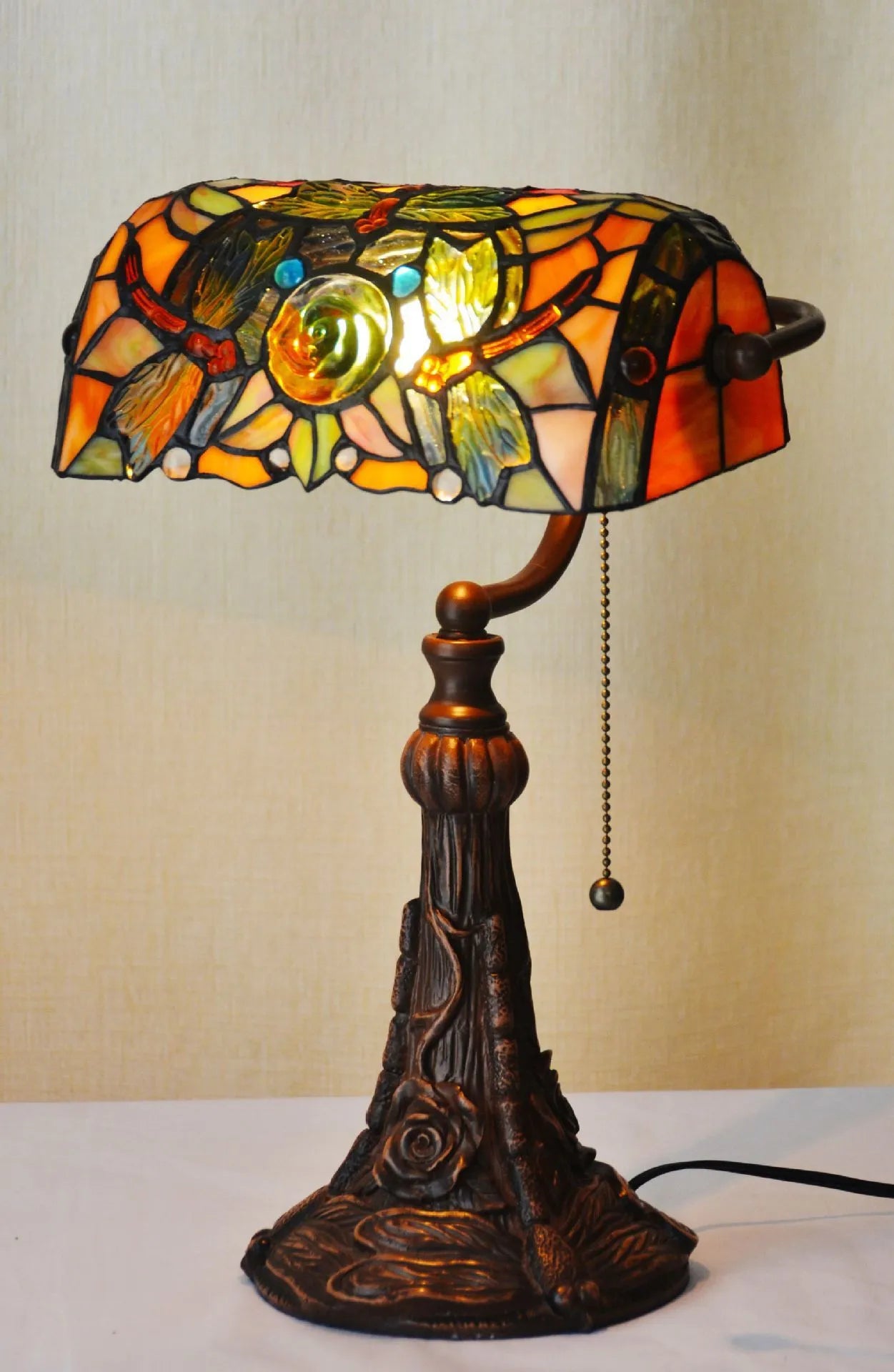 10-inch Tiffany table lamp with coloured stained glass resin shade on a desk.