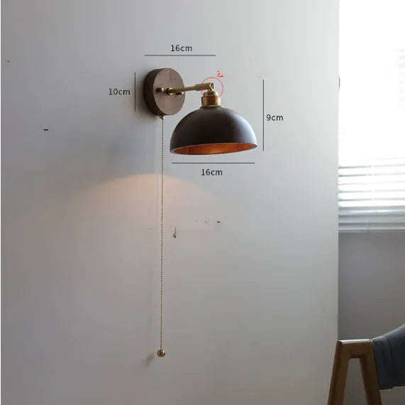 Inn Niche Nordic style wooden finish wall mounted bedside lamp with a neutral shade.