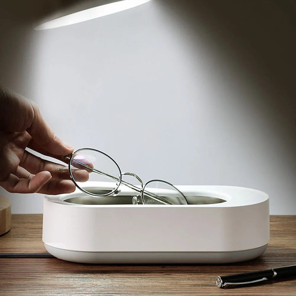 White portable ultrasonic cleaning machine with a stainless steel tank for jewellery and glasses.