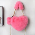 A soft, heart-shaped plush handbag for women in a medium size with a detachable shoulder strap.