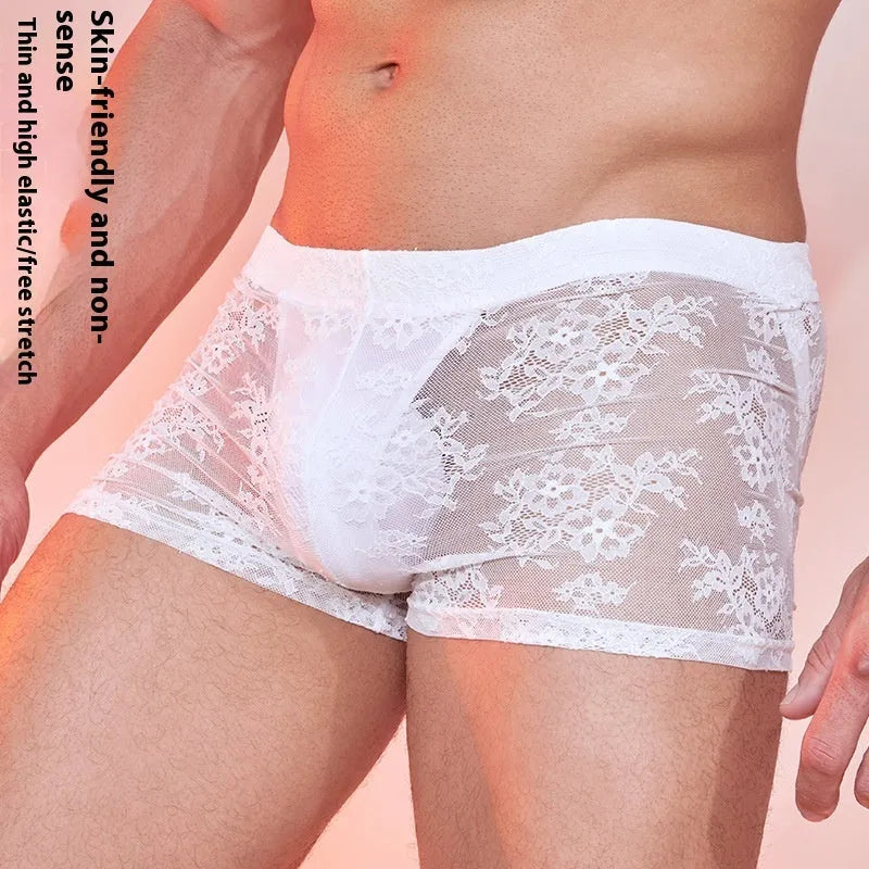 Black lace-trimmed men's nylon boxer briefs laid flat, showing elasticated waistband.