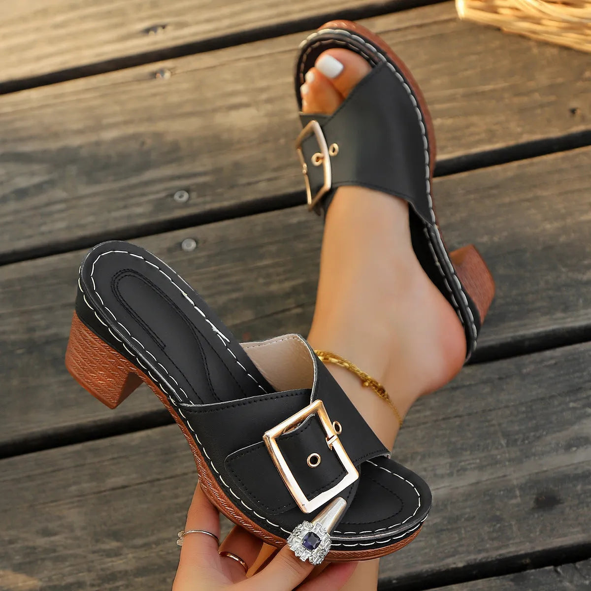 Women's retro chunky heel slippers with a metal buckle in black and light blue colours.