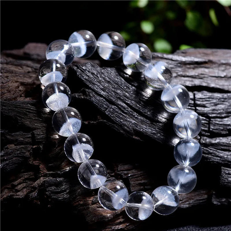 Women's white crystal ghost pyramid bracelet with ruyi symbol on wrist, showing adjustable bead sizes.