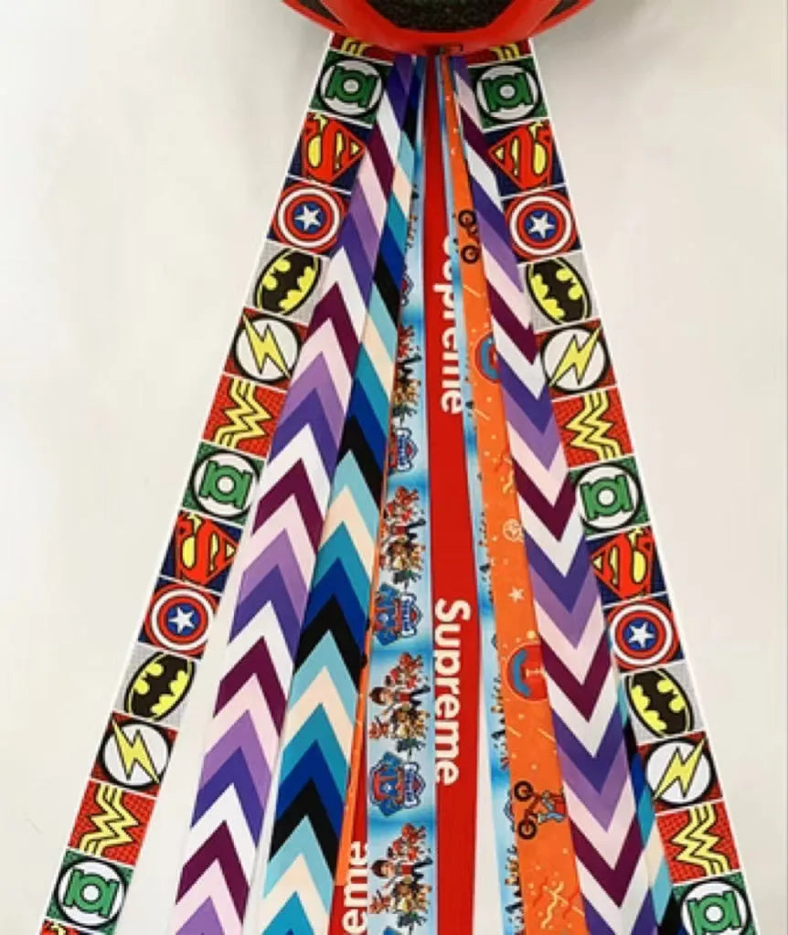 Colourful decorative ribbon streamers attached to a children safety helmet for skating or skiing