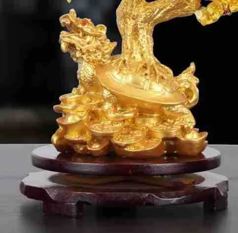 Citrine-coloured resin turtle money tree Feng Shui ornament on display.