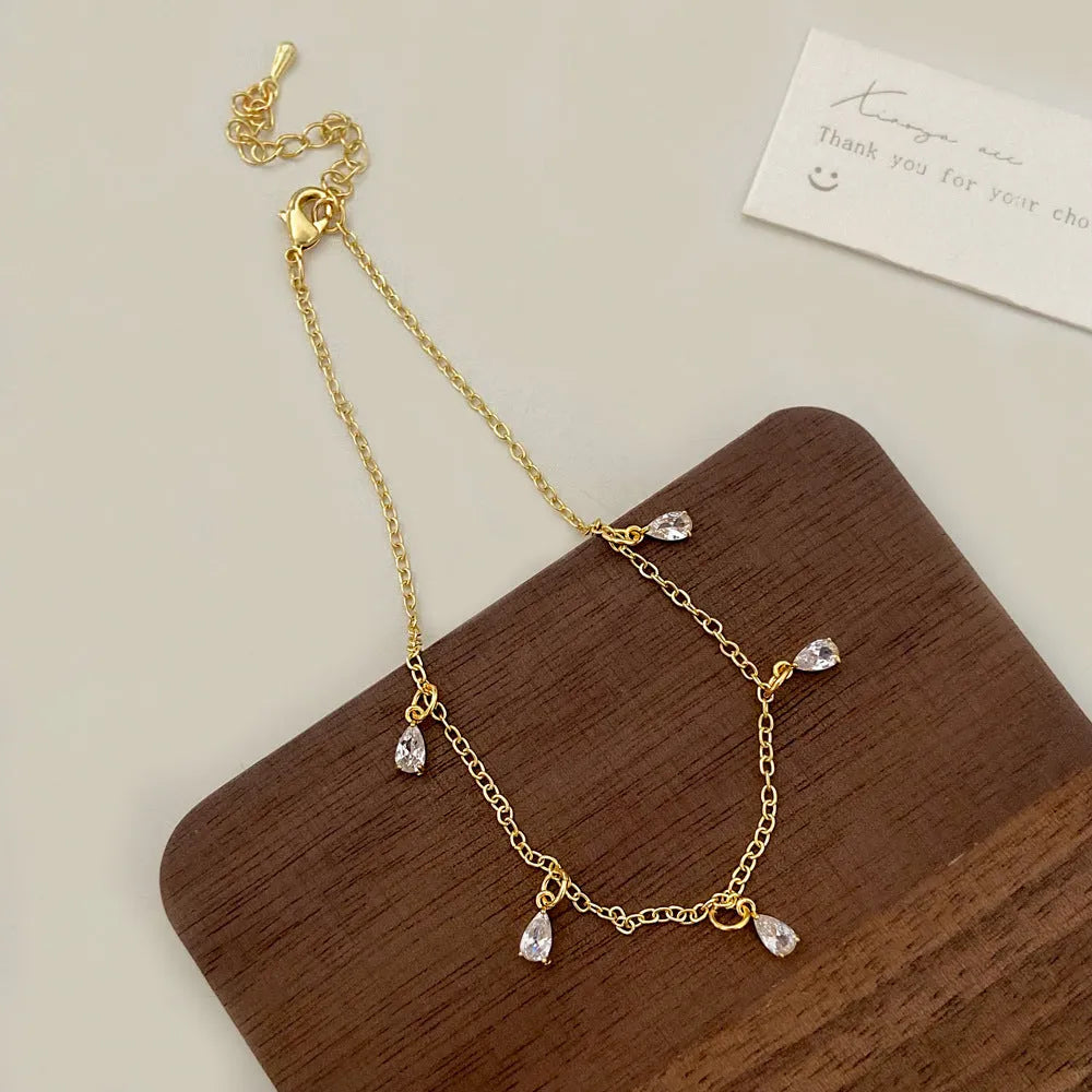 Zircon jewellery set showing necklace, earrings, and anklet with geometric meteor shower design