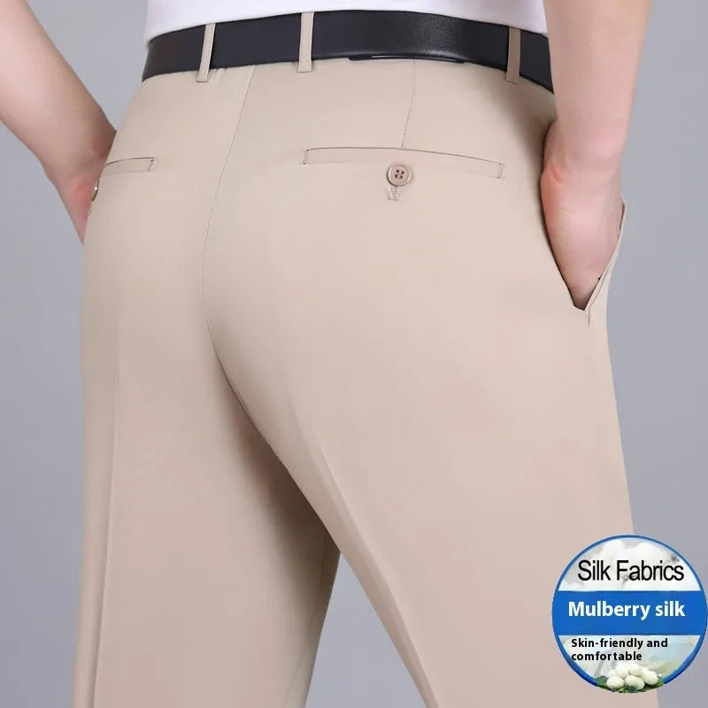 Man wearing dark blue straight-leg suit pants with a high waist, made from a non-ironing mulberry silk blend fabric.