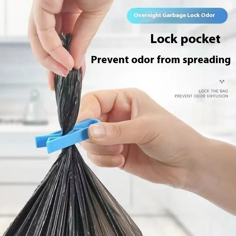 White PP plastic non-slip clip holding a black bin liner to the side of a silver kitchen trash can.